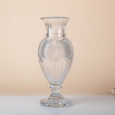a clear glass vase sitting on a white table