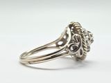 a close up of a silver ring with a flower design on it