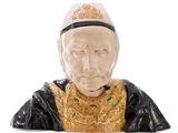 a figurine of a man with a hat on his head