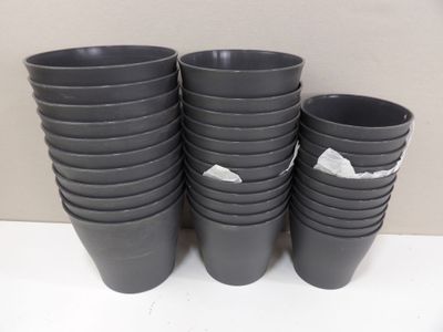 several black plastic cups are stacked on top of each other