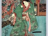 an image of a woman in a green kimono robe holding a fan