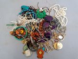 a pile of assorted jewelry sitting on a table