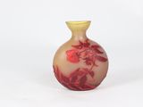 a small vase with a red and yellow design on it