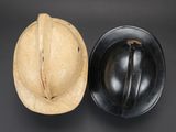 an old helmet and a hard hat on a black background