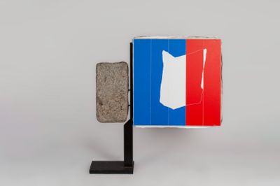 an image of a french flag with a stone block in front of it
