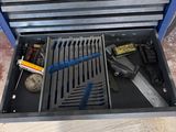 a tool box with tools inside of it on the floor