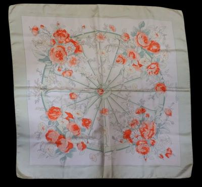 an image of a white handkerchief with orange flowers on it