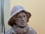 a statue of a man wearing a hat and a coat