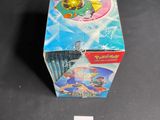 a box of pokemon cards on a table next to a ruler