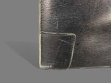 leather wallet on grey background with clippings for money