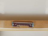 a wooden shelf with a knife on top of it