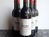 several bottles of wine are lined up on a table