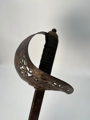 a close up of a sword with a curved blade