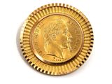 a close up of a gold coin on a white surface