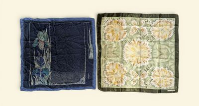 two pieces of fabric with flowers on them on a table