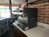 a coffee machine sitting on a counter in a kitchen