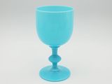 a blue glass cup sitting on top of a white table