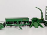 a green toy tractor with a trailer and a trailer with a green tractor and a trailer with a green tractor and a green trailer with a green tractor