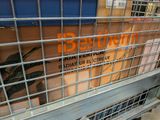 a metal cage with a sign on it in a store