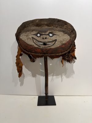 a small wooden table with a face on it