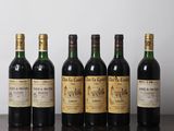six bottles of wine are lined up on a wooden table
