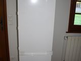 a white refrigerator in the corner of a room