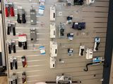 a wall with many different items on it in a store