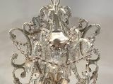 a silver chandelier hanging from a chain