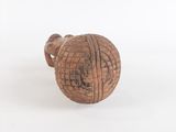 an old wooden ball with a hole in it on a white surface