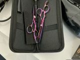 two pairs of scissors in a case on a table