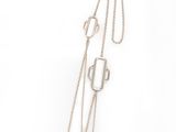 silver necklace with geometric shapes on a chain on a white background