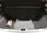 the trunk of a car with a bottle of beer in it