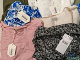 a lot of clothes that are sitting on a bed
