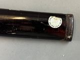 a bottle with a sticker on it sitting on a table