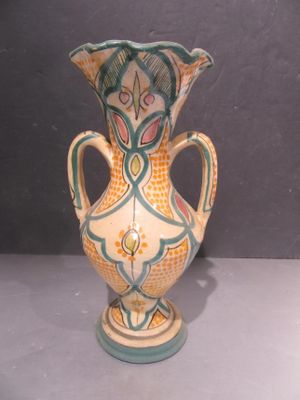a vase that is sitting on a table with a gray background