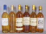 six bottles of wine are lined up in a row on a table