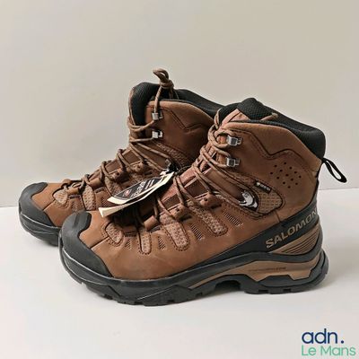 brown hiking boots on a white surface with a white background