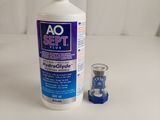 an image of a bottle of o2 shot next to a shot glass