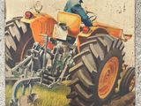 a picture of a man riding a tractor on the cover of a magazine