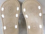 the soles of a pair of shoes with white dots on them