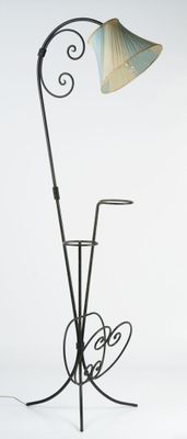 a lamp that is on a stand with a lamp on it