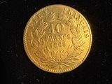 gros plan d'une pièce d'or sur une surface noire