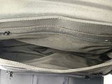 a bag that is sitting on top of a suitcase