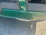 a close up of a green car door handle