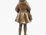 bronze figurine of a girl with a hat and dress