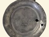 a silver plate with a hole in the middle of it