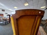 an image of a chair in a room with a lot of furniture in the background