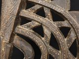 a close up of a wooden sculpture of a bird on a black background