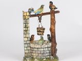 a figurine of a fountain with birds on it