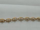 un bracelet de perles dorées exposé dans la vitrine d'un magasin